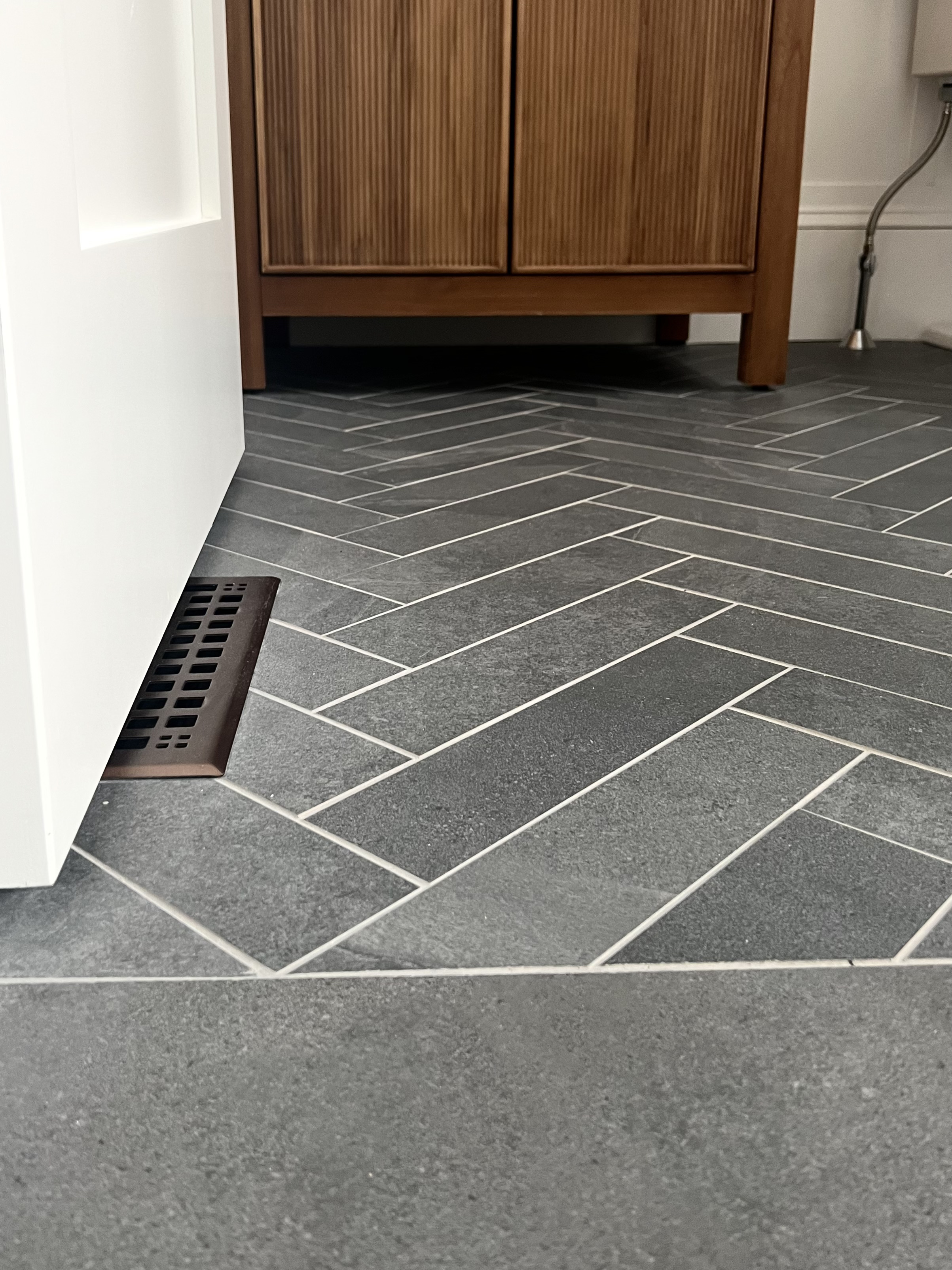 Herringbone tile floor in a hallway